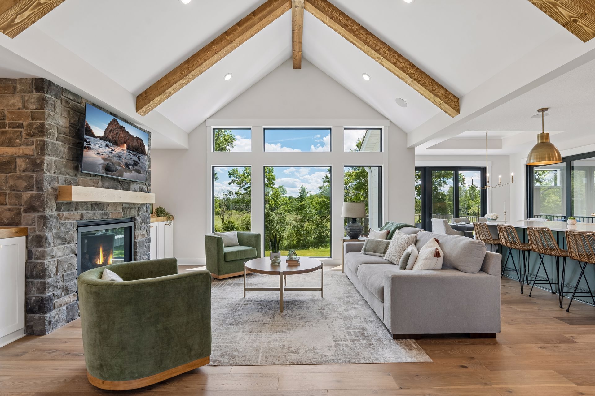 Great room with floor to ceiling windows overlooking wooded views